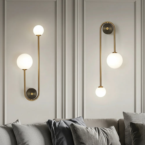 Two modern wall lights with gold fixtures and white globe bulbs on a gray wall, with 'AumgTaiy' branding and product details.