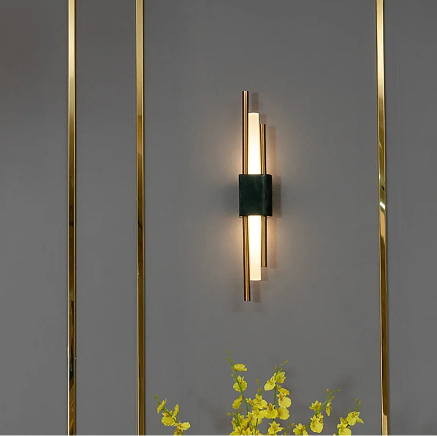 Modern wall-mounted light fixture on a gray wall with decorative elements.